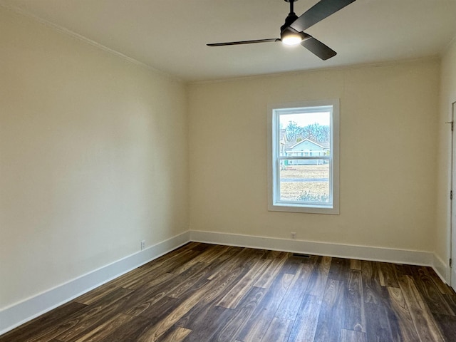 empty room with dark hardwood / wood-style flooring and ceiling fan