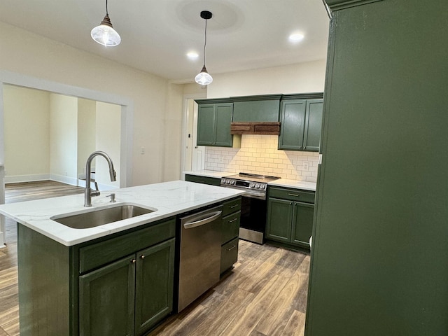 kitchen featuring sink, appliances with stainless steel finishes, hanging light fixtures, light stone counters, and a kitchen island