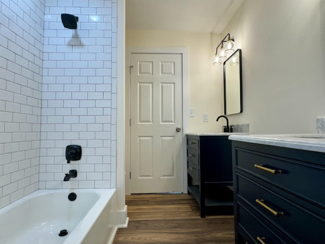 bathroom featuring vanity, hardwood / wood-style flooring, and tiled shower / bath combo