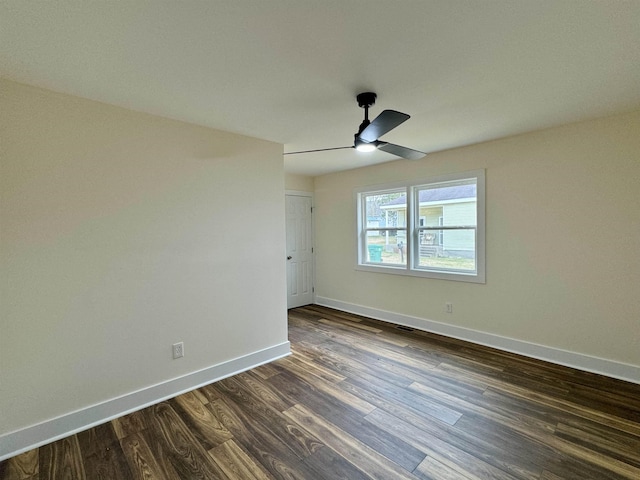 spare room featuring ceiling fan and dark hardwood / wood-style flooring