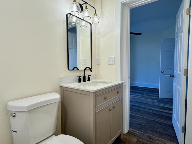 bathroom featuring hardwood / wood-style flooring, vanity, and toilet