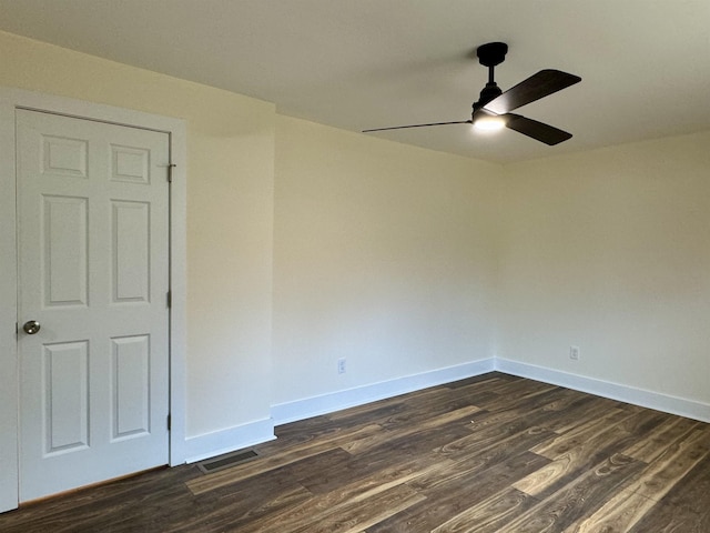 spare room with dark hardwood / wood-style floors and ceiling fan