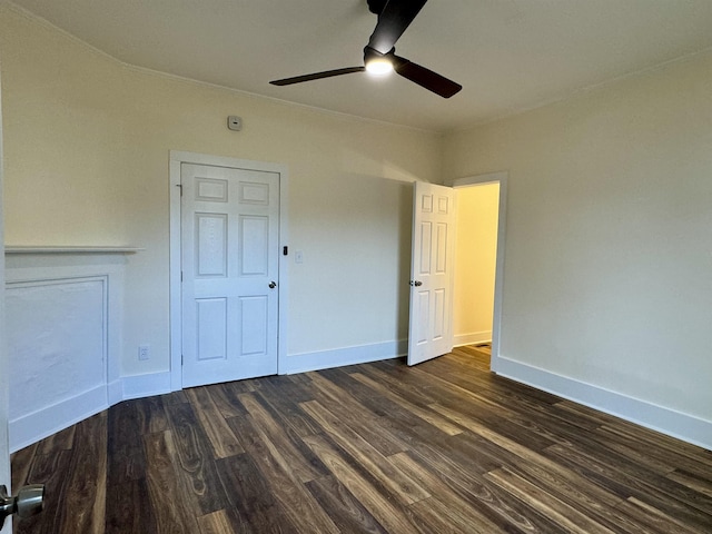 unfurnished bedroom with dark wood-type flooring and ceiling fan