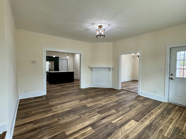 unfurnished living room featuring dark hardwood / wood-style flooring