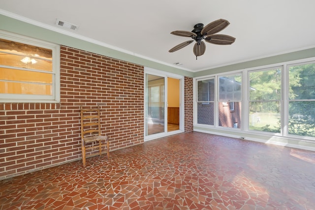 unfurnished sunroom with ceiling fan