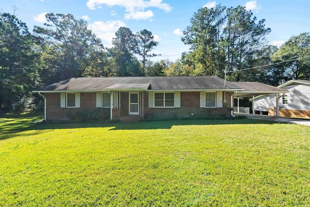 ranch-style home featuring a carport and a front lawn