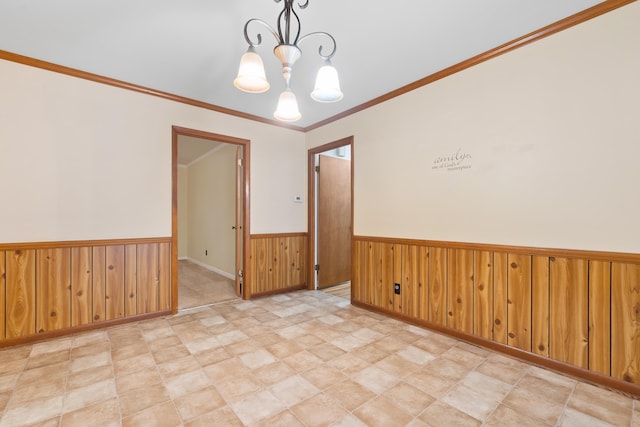 unfurnished room with ornamental molding, a chandelier, and wood walls