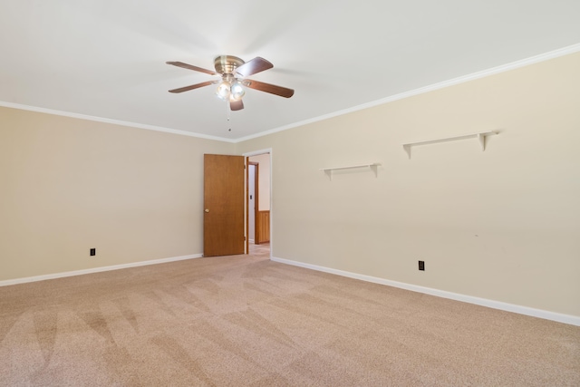 spare room with crown molding, light colored carpet, and ceiling fan