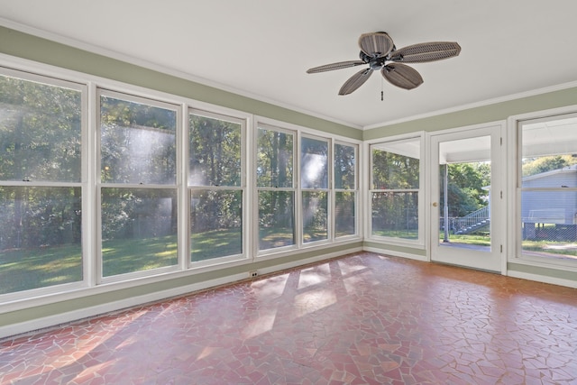 unfurnished sunroom with ceiling fan