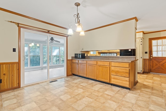 kitchen featuring crown molding, decorative light fixtures, wooden walls, kitchen peninsula, and ceiling fan