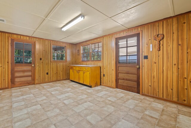 entryway featuring wooden walls