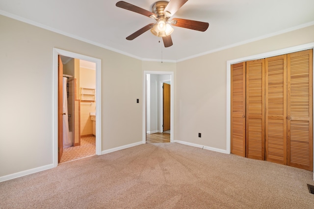 unfurnished bedroom with light carpet, ornamental molding, a closet, and ceiling fan