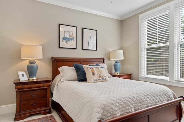 bedroom with crown molding and light carpet