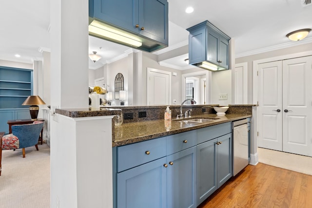 kitchen featuring sink, stainless steel dishwasher, ornamental molding, kitchen peninsula, and dark stone counters