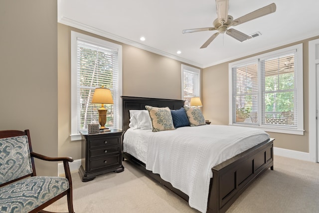 bedroom with light carpet, crown molding, and ceiling fan