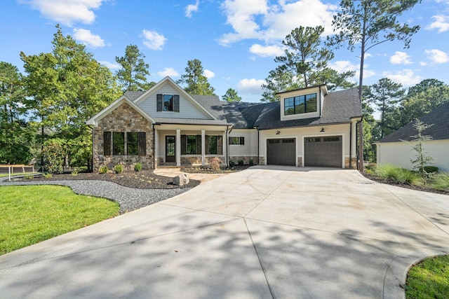 craftsman-style house featuring a porch, a garage, and a front yard