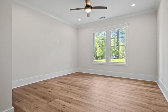 empty room with crown molding, light hardwood / wood-style floors, and ceiling fan