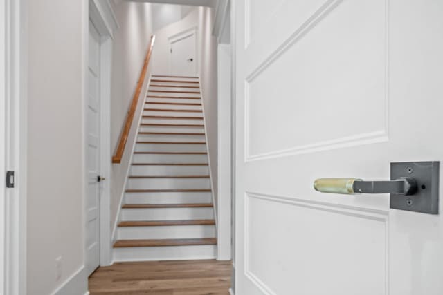 stairs featuring hardwood / wood-style flooring