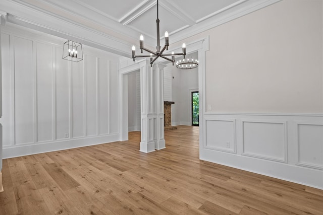 unfurnished dining area featuring crown molding, light hardwood / wood-style flooring, a chandelier, coffered ceiling, and beamed ceiling