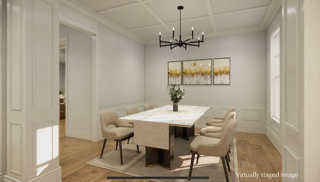 dining room with ornamental molding, coffered ceiling, an inviting chandelier, and light wood-type flooring