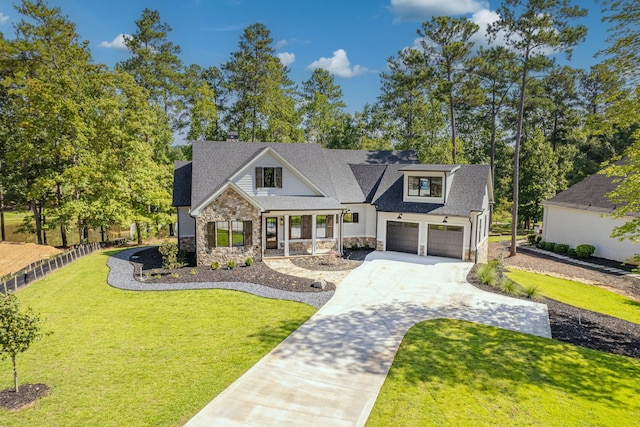 view of front of property featuring a garage, a front lawn, and covered porch