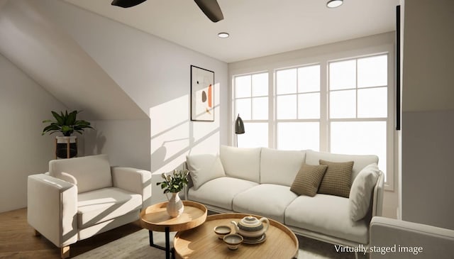 living room featuring hardwood / wood-style flooring, vaulted ceiling, and ceiling fan