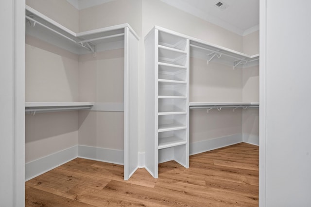 spacious closet with hardwood / wood-style floors