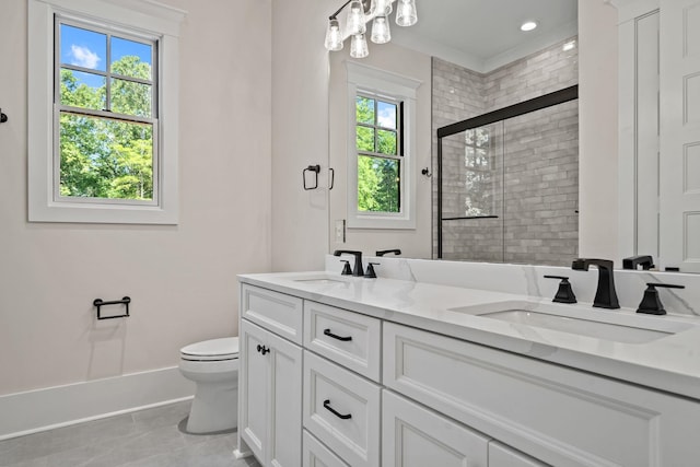 bathroom featuring vanity, toilet, a healthy amount of sunlight, and walk in shower