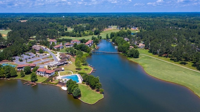 drone / aerial view featuring a view of trees and a water view
