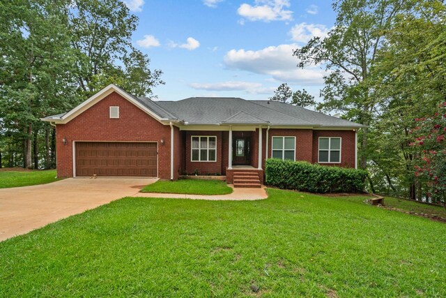 ranch-style house featuring a garage and a front lawn