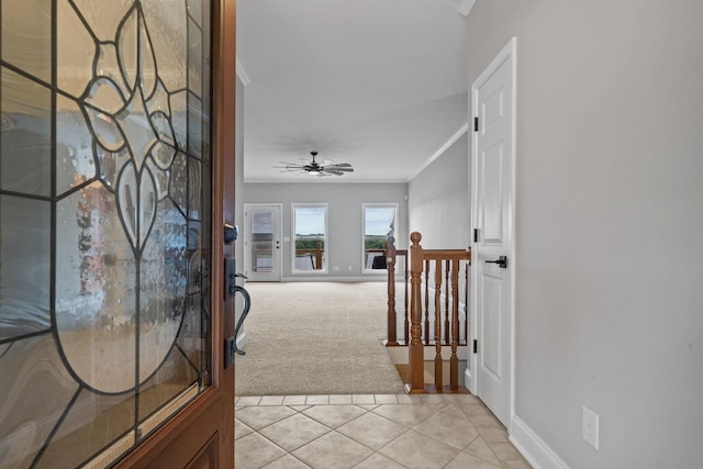 hallway with crown molding and light carpet