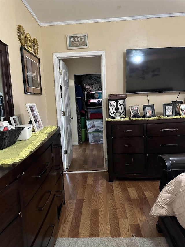 bedroom featuring ornamental molding and dark wood-type flooring