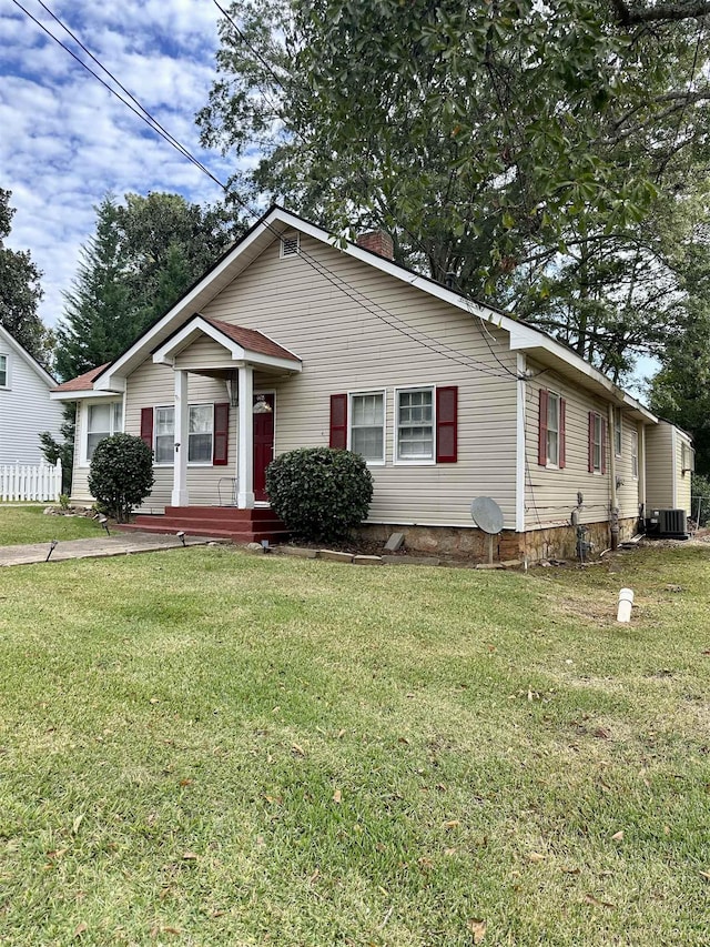 view of front of house featuring a front yard and central air condition unit