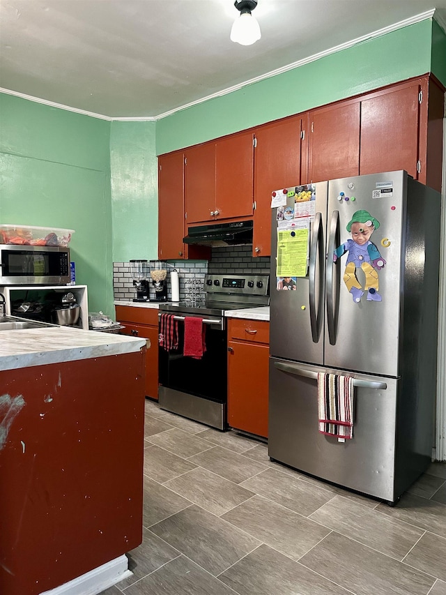 kitchen featuring tasteful backsplash, appliances with stainless steel finishes, and sink