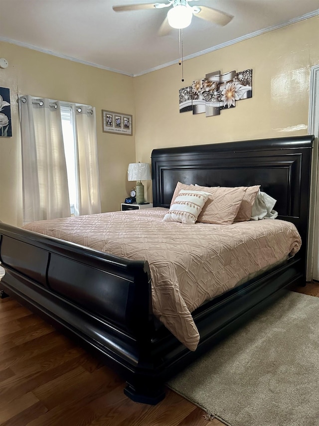 bedroom featuring ceiling fan, ornamental molding, and dark hardwood / wood-style floors