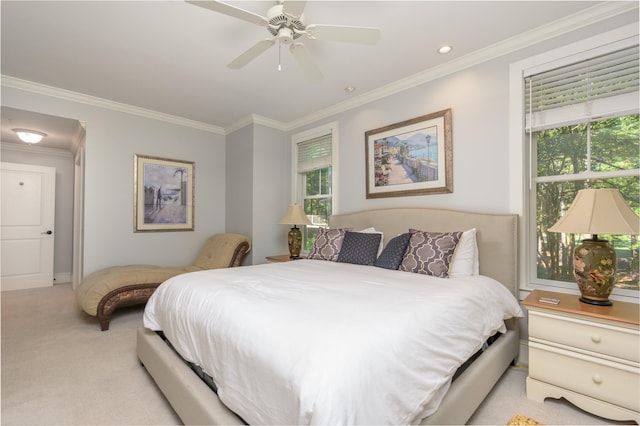 carpeted bedroom with ornamental molding and ceiling fan