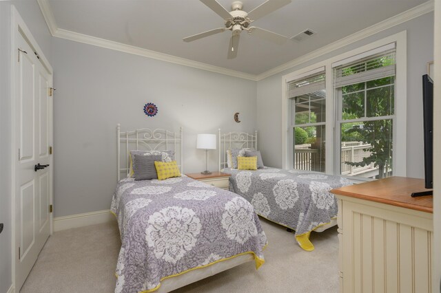 bedroom featuring crown molding, light colored carpet, and ceiling fan