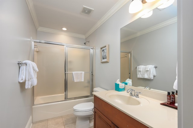 full bathroom featuring tile patterned floors, toilet, crown molding, vanity, and enclosed tub / shower combo