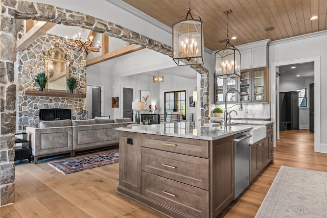 kitchen with a notable chandelier, stainless steel dishwasher, wooden ceiling, a fireplace, and glass insert cabinets