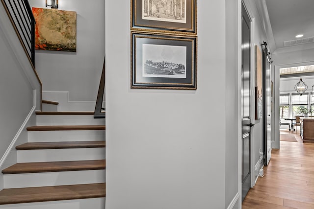 stairs featuring visible vents, wood finished floors, recessed lighting, a barn door, and baseboards