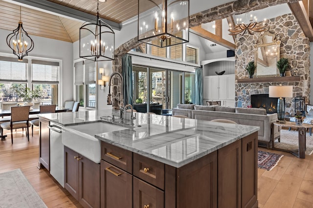 kitchen featuring an inviting chandelier, a fireplace, a sink, wood ceiling, and light wood-type flooring