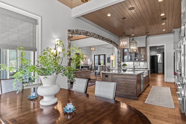 dining room featuring plenty of natural light, a notable chandelier, wood ceiling, and light wood-style flooring