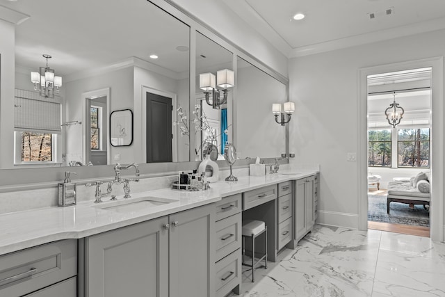 bathroom featuring visible vents, marble finish floor, ornamental molding, a sink, and an inviting chandelier