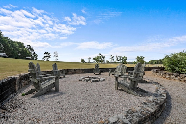 view of yard featuring a rural view and an outdoor fire pit