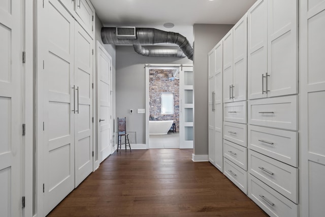 hall with dark hardwood / wood-style flooring and a barn door