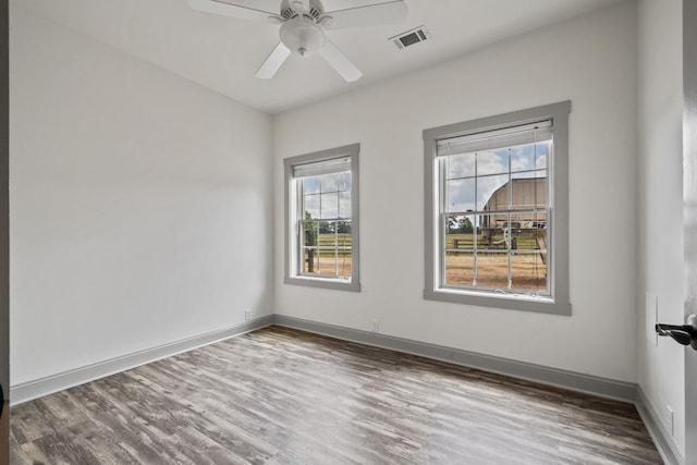 spare room with wood-type flooring and ceiling fan