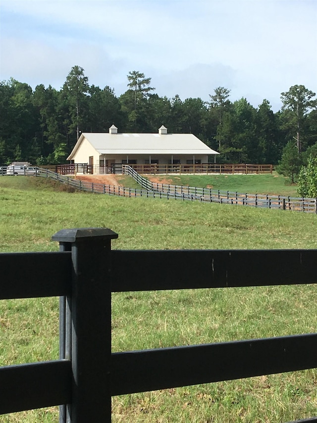 view of yard featuring an outbuilding and a rural view