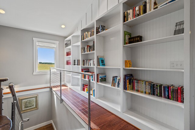 hall with hardwood / wood-style flooring