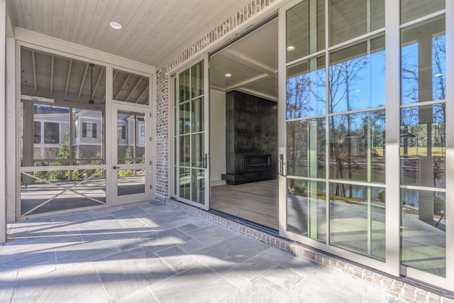 exterior space featuring plenty of natural light, wooden ceiling, and a water view