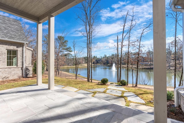 view of patio with a water view